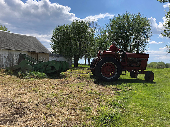 Pulling corn picker out to orchard pasture